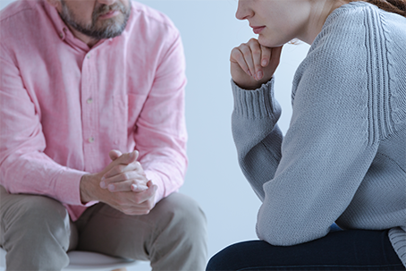 a man and woman talking about grief