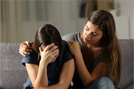 a woman consoling a woman